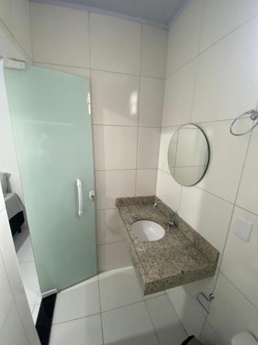 a bathroom with a sink and a mirror at Pousada Valente in Barreirinhas