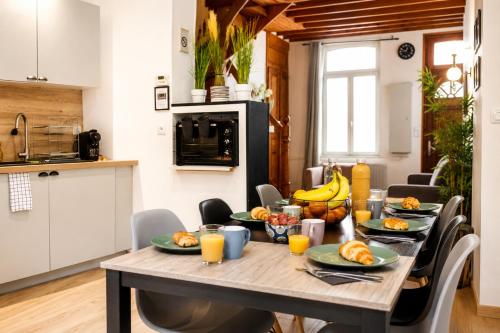a table with fruit on it in a kitchen at Le Triplex Confort I Parking gratuit I Centre Amiens in Amiens