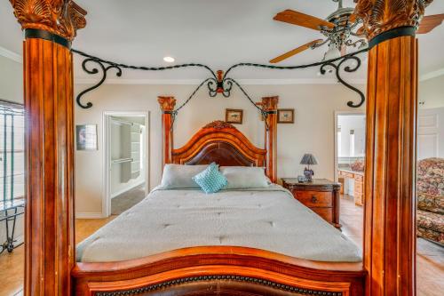 a bedroom with a wooden bed with a wooden frame at Red Oak Group Getaway w/ Yard + Patio in Red Oak