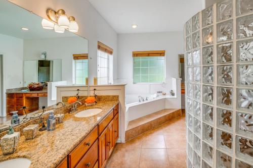 a bathroom with two sinks and a large mirror at Red Oak Group Getaway w/ Yard + Patio in Red Oak