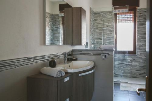 a bathroom with a sink and a mirror at Il Rovo Rooms in Porto Torres