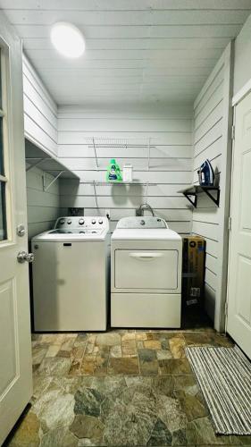 a kitchen with a stove and a washer and dryer at Flawless one bedroom apartment! in Houston