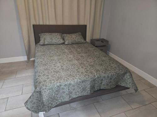 a bedroom with a bed with a comforter and pillows at Flawless one bedroom apartment! in Houston