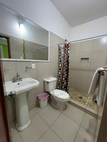 a bathroom with a toilet and a sink and a mirror at Hotel Playa Azul in Catemaco