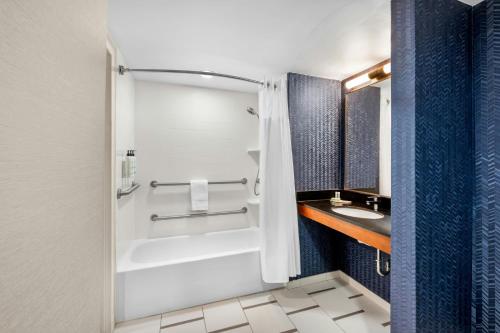 a bathroom with a shower and a sink at Fairfield Inn Boston Woburn in Woburn