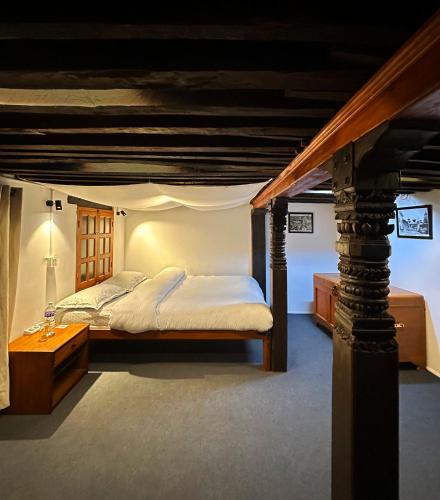 a bedroom with a bed and a table in a room at Newa Inn Homestay in Kathmandu