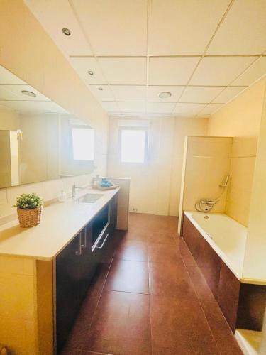a large kitchen with a sink and a tub at Casa La Fuente in Chella
