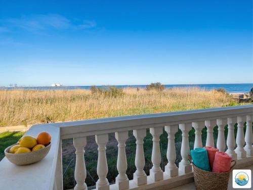 a bowl of fruit on a balcony overlooking the ocean at Adosado Primera línea de mar Playa de Puzol con Piscina y terrazas in Playa de Mar