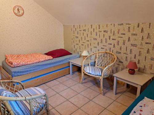 a bedroom with a bed and a table and chairs at Marmotte Le Monêtier Apartment in Le Monêtier-les-Bains
