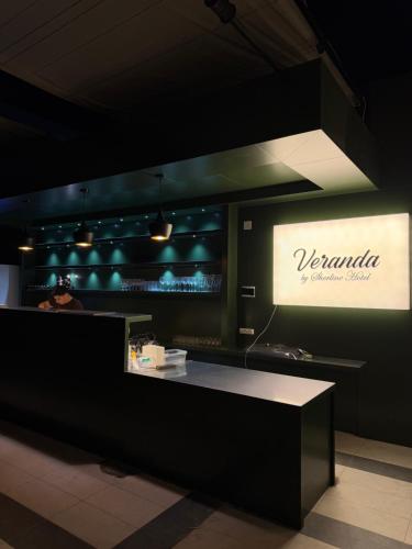 a woman standing at a counter in a restaurant at Sherline Hotel in Urganch
