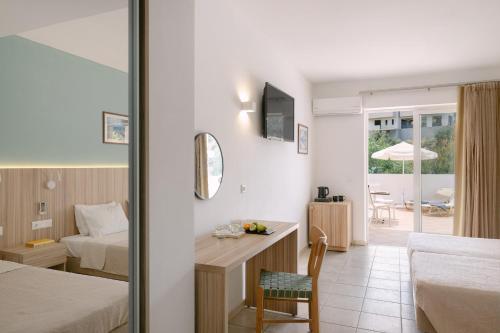 a hotel room with a bed and a desk with a chair at Xidas Garden in Bali