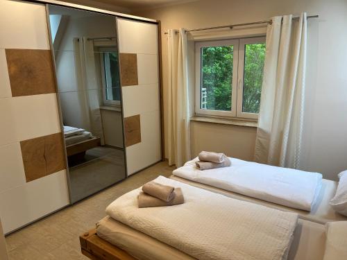 a bedroom with two beds and a large mirror at Apartment P&T Top 5 in Altenhof