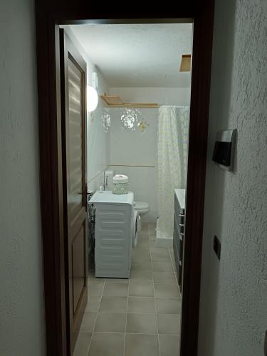 a bathroom with a sink and a toilet and a tub at Nonna Lidie in Aymavilles