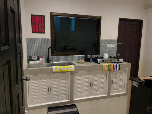 a bathroom with a sink and a mirror at Krabi Buddy House in Ban Khlong Chi Lat