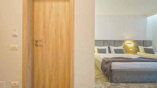a door leading to a bedroom with a bed at Sub Cetate in Râşnov