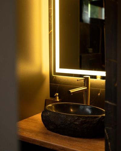 a bathroom sink with a large stone sink at Silence cabin in Myta