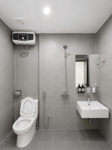 a bathroom with a toilet and a sink at Dreamora Serenity Hotel & Residence in Hanoi