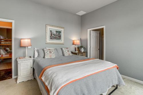 a bedroom with a large bed and two lamps at Sunset View Deck! Lake Eufaula Family Getaway in Stigler