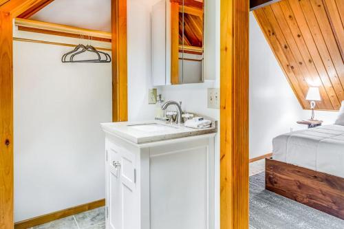 a bathroom with a sink and a bed in a room at Alderbrook A-Frame in Union