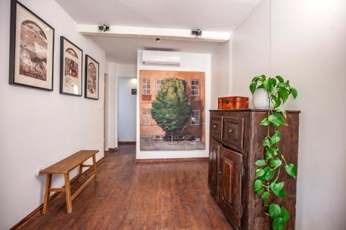 a room with a table and a bench and a painting at Central Art House Hvar in Hvar
