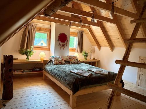 a bedroom with a large bed in a attic at Górska Osada Berdo in Chmiel