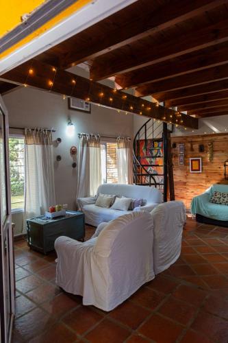 a living room with white couches in a room at Casa Paso de la Patria in Corrientes