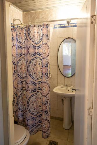 a bathroom with a shower curtain and a sink at Casa Paso de la Patria in Corrientes