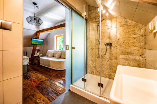 a bathroom with a shower with a glass door at Gospoda Dębowiec520 in Bielsko-Biała