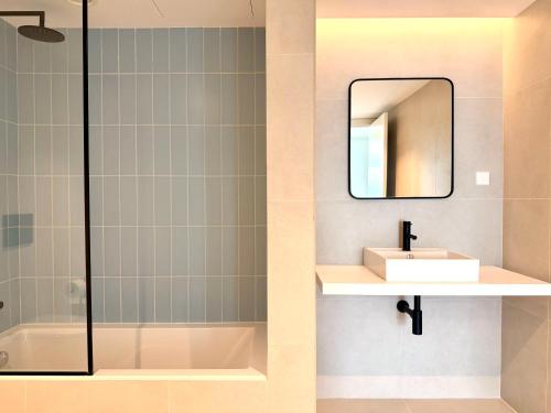 a bathroom with a sink and a mirror at Nooba Barreiro Apartment in Barreiro