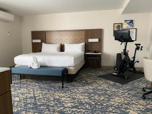 a hotel room with a bed and a desk and a television at DoubleTree by Hilton Tinton Falls-Eatontown in Tinton Falls