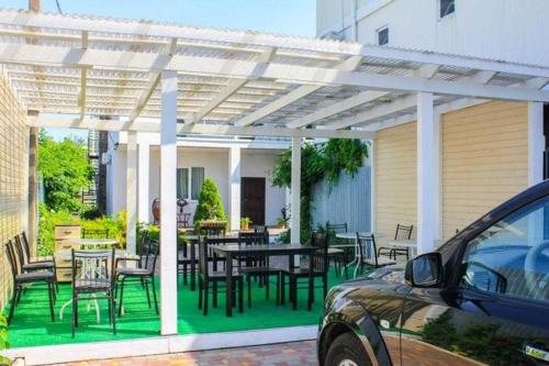 a pergola with a table and chairs on a patio at Villa Klavia in Zatoka