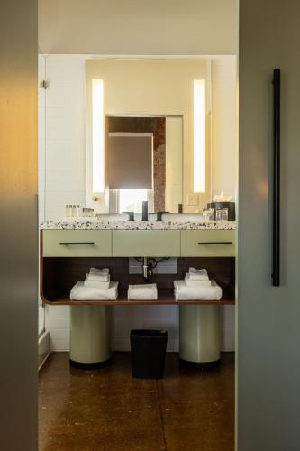 a bathroom with a sink and a mirror at Canvas Hotel Dallas in Dallas