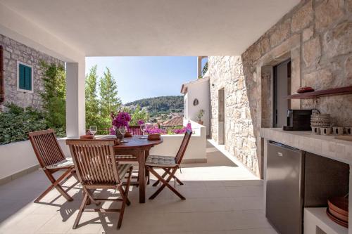 a kitchen and dining room with a table and chairs at Central Art House Hvar in Hvar