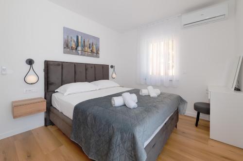 a bedroom with a bed with two pillows on it at Villa Rocco in Srima