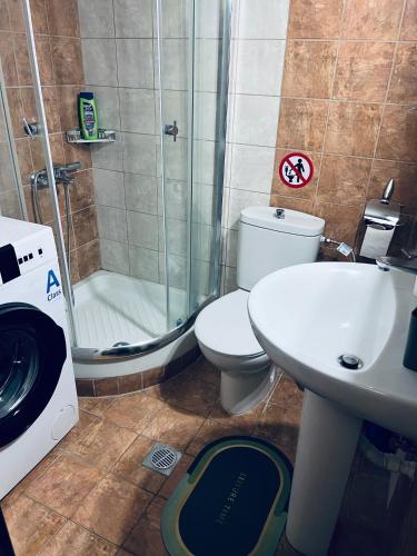 a bathroom with a shower and a toilet and a sink at Afytos house in Afitos