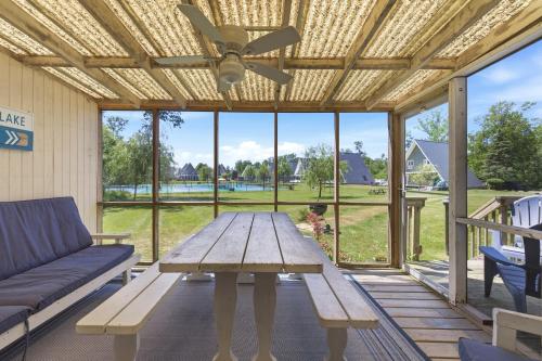 a patio with a wooden table and a couch at Chalet 71 in Stevensville
