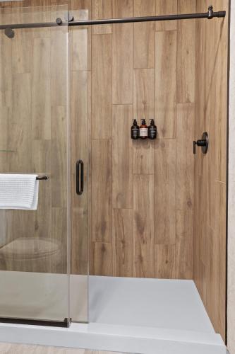 a shower with a glass door in a bathroom at The Wills Hotel in Cumberland