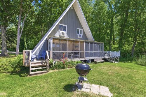 a house with a grill in the yard at Chalet 71 in Stevensville