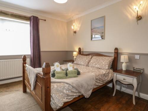 a bedroom with a bed with two stuffed animals on it at Bay Cosy in Pevensey
