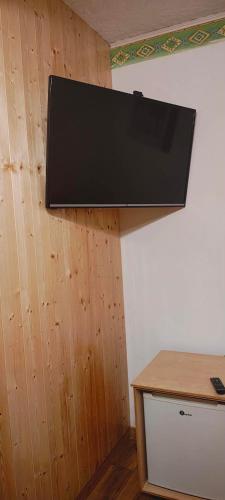 a flat screen tv hanging on a wall at Letni Domek , Ogrzewany, z bilardem in Ruciane-Nida