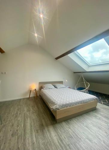 a bedroom with a bed and a large window at Sabrina in Tarbes