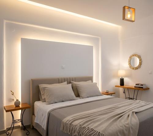 a bedroom with a large bed with two tables at Moussa Erato in Agia Anna Naxos