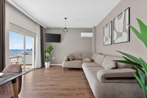 a living room with a couch and a table at Wave Beachfront Apartments in Durrës