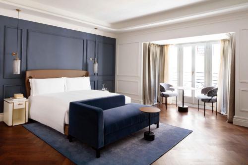 a bedroom with a bed and a blue wall at InterContinental Rome Ambasciatori Palace by IHG in Rome