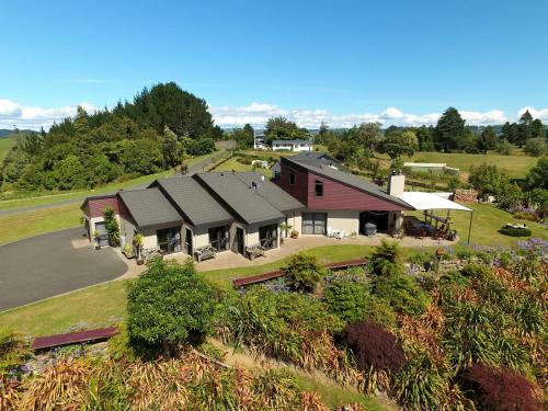 an aerial view of a home with a barn at Waitomo Golfstays B&B in Otorohanga