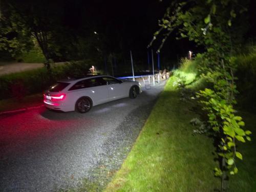 a white car driving down a road at night at Nad Strumieniem in Pieszyce