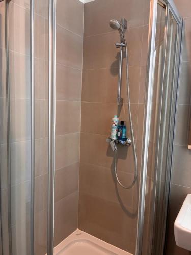 a shower with a glass door in a bathroom at Ridzak Riva Rooms in Mali Lošinj