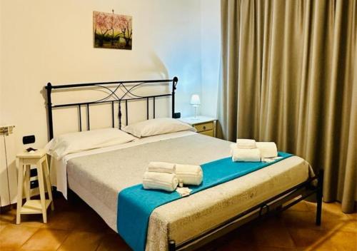 a bedroom with a bed with towels on it at Near Acquamorta Beach - Villa Lamberti Casa Sole in Monte di Procida