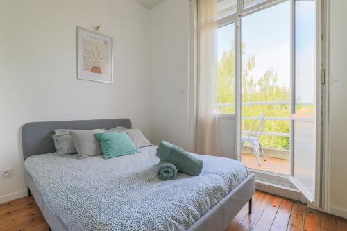 a bedroom with a bed and a large window at Suite Number 14 in Liévin