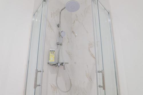 a shower with a shower head in a bathroom at Suite Number 14 in Liévin